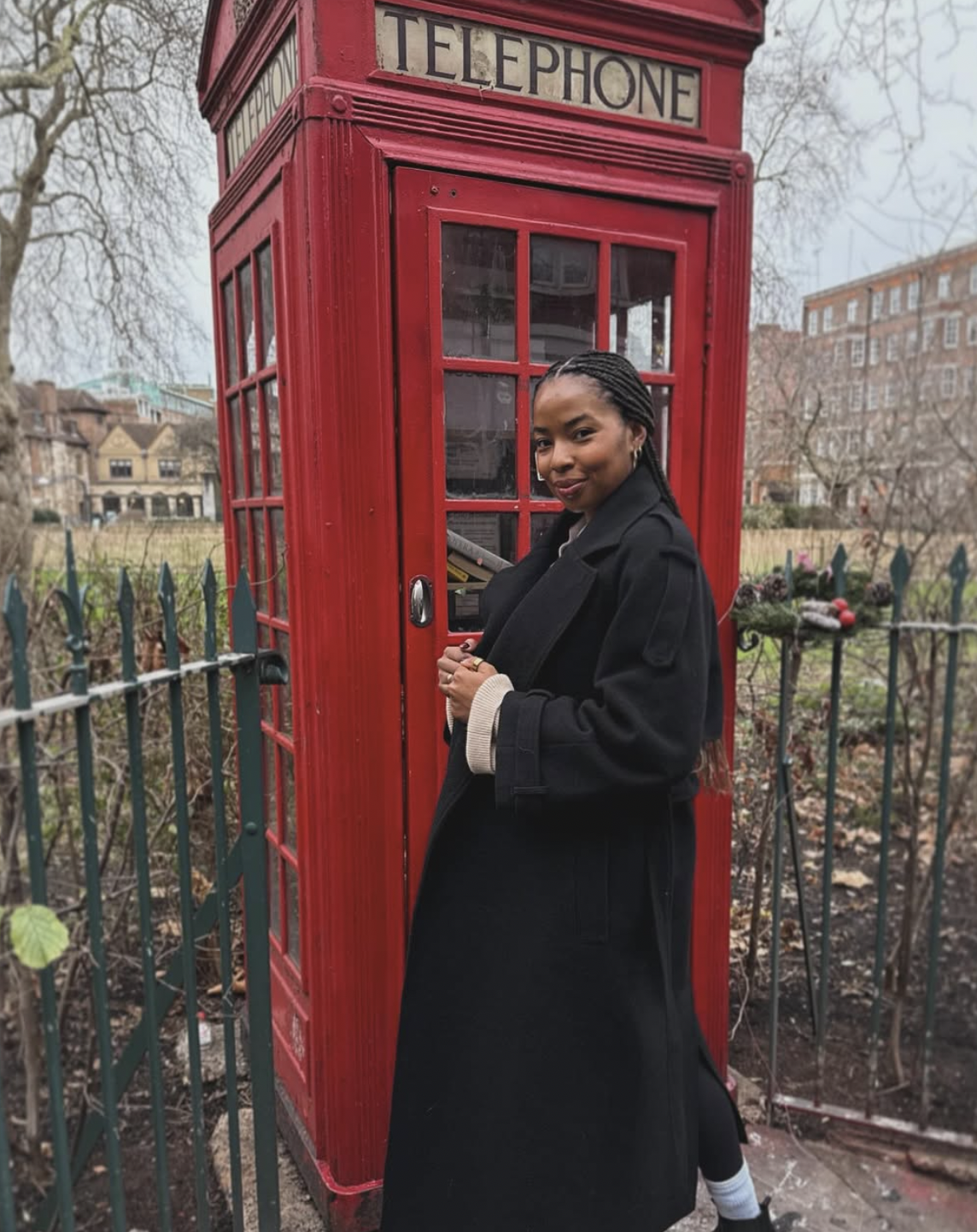 London Move Kira West Black girl in coat in front of London phone booth